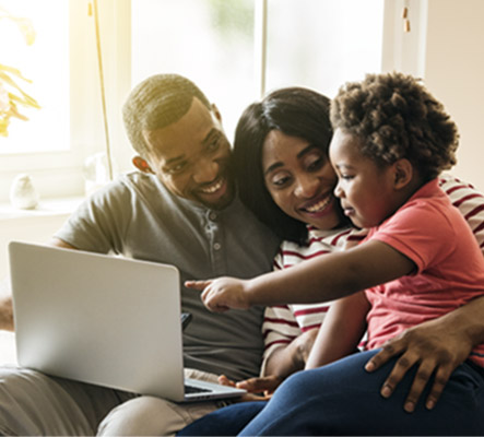 Family at home on laptop.